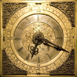 A large golden clock face denoting time 