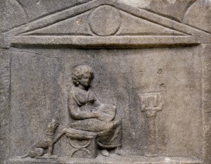 Gravestone of Avita, who is reading from a scroll; second scroll on a reading-stand. © Trustees of the British Museum