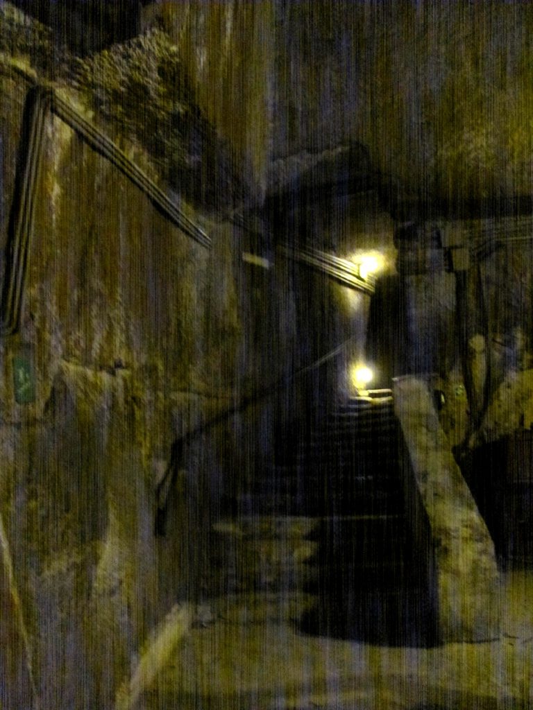 Dark tunnel under Naples, steps going up, a light at the top. My photo taken 2015 https://alison-morton.com