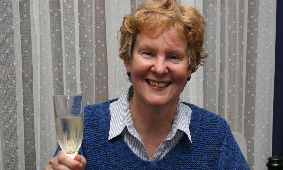 Alison raising a glass of champagne - cheers!